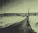 A path with a electric pole on the side.