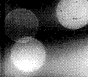 An out of focus shot of light glare forming circles, taken in 2 bit black and white.